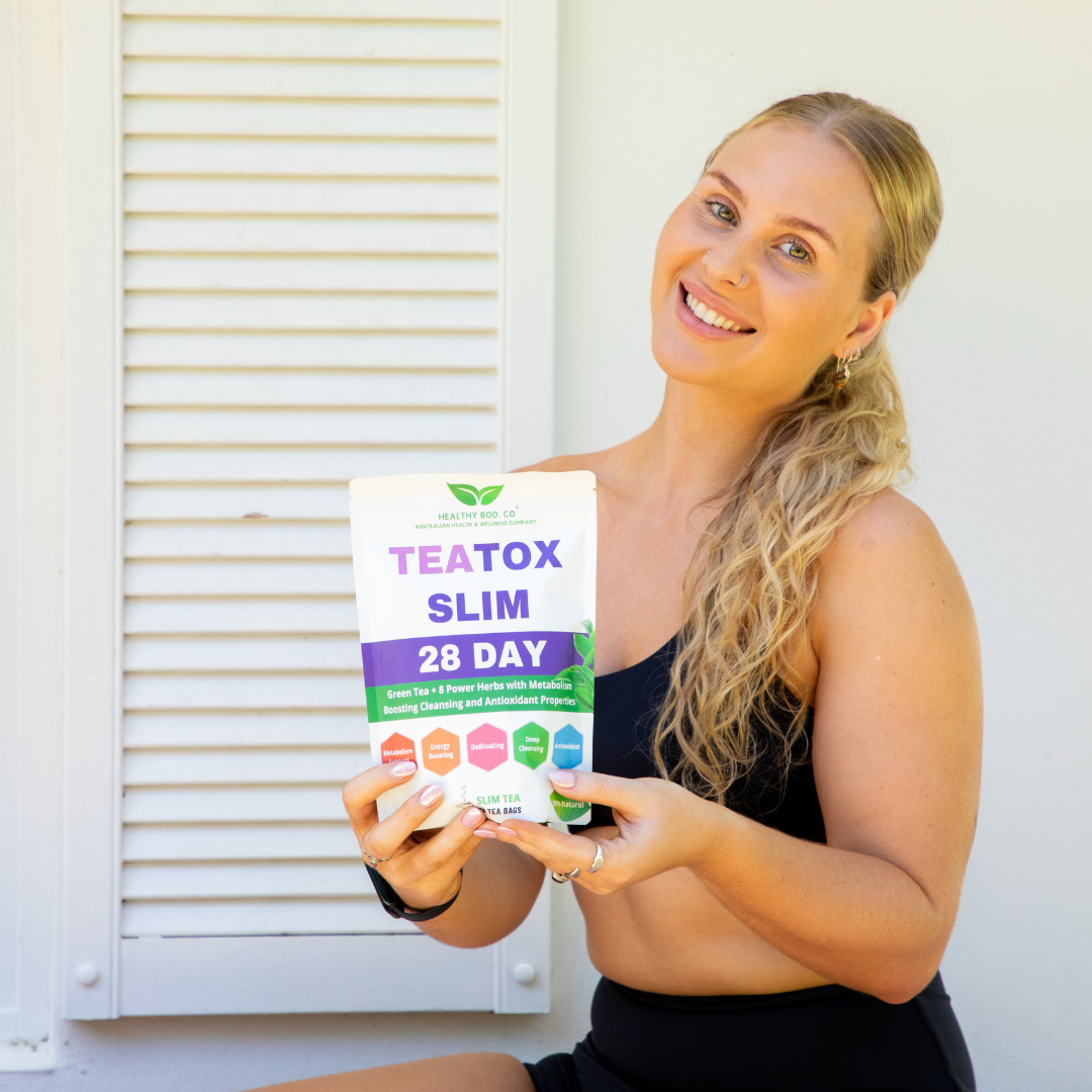 An image of a woman holding the Healthy Bod Co 28 Day TeaTox Slim Tea in front of her house